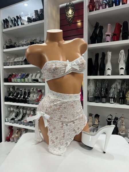 White floral lace bandeau top and high waist draped skirt lingerie set with satin bows displayed on mannequin in boutique showroom
