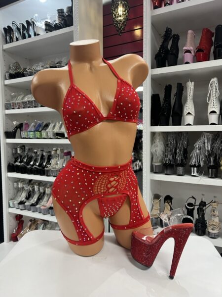 Red rhinestone lingerie chaps set with triangle bra, thong, and open-leg high waist chaps displayed on mannequin in boutique