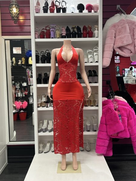 Red lace halter gown with smooth stretch fabric and sheer floral lace skirt displayed on mannequin in boutique showroom