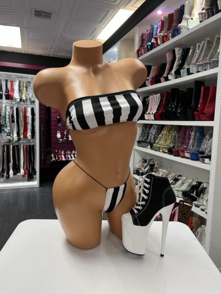 Black and white striped bandeau micro bikini set with thong bottom displayed on mannequin in boutique showroom