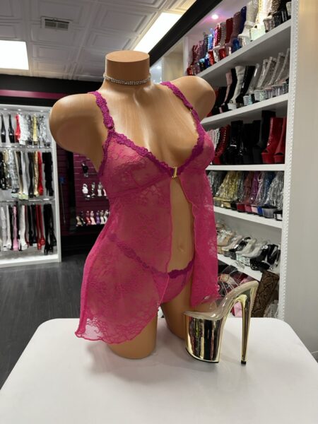 Fuchsia lace babydoll lingerie set with sheer top and matching thong displayed on mannequin in boutique showroom
