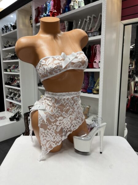 White floral lace bandeau top and high waist draped skirt lingerie set with satin bows displayed on mannequin in boutique showroom