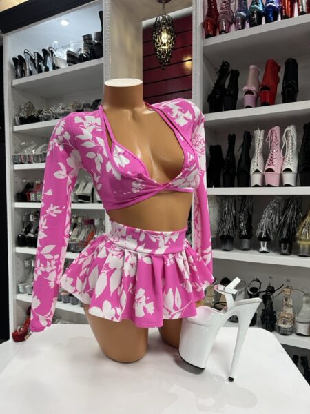 Four-piece pink floral outfit featuring a halter bra top, mini skirt, thong bottom, and matching long sleeve shrug.