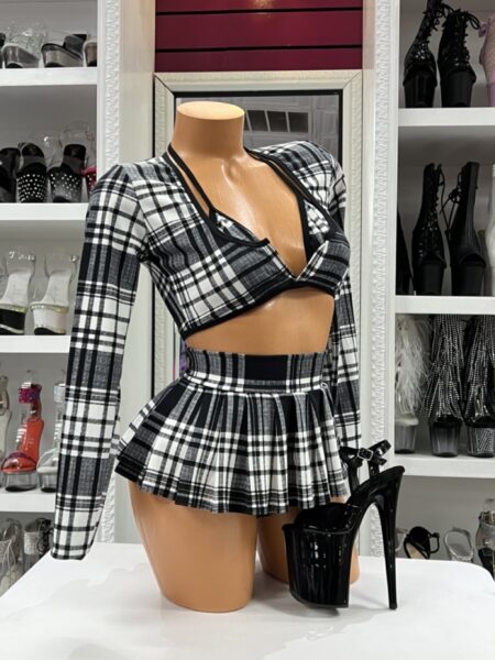 Model wearing midnight plaid skirt set with long sleeve crop top and pleated mini skirt