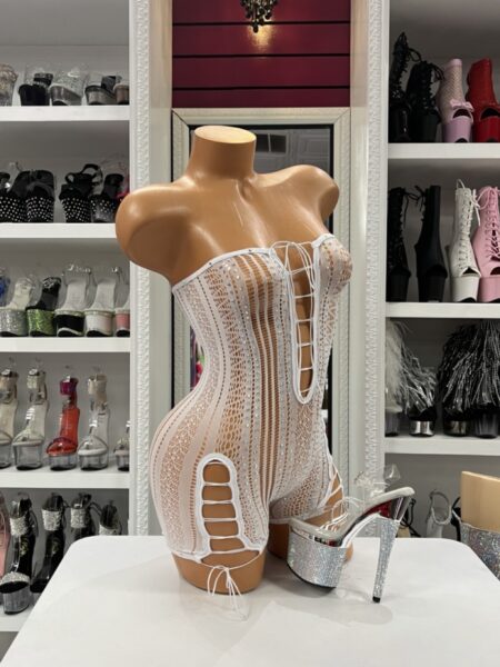 Model wearing white rhinestone lace romper with strapless lace-up front and crystal detail