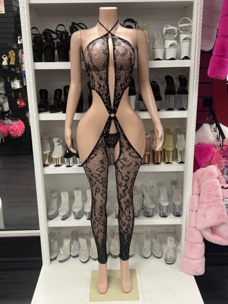 Model wearing black rhinestone lace catsuit with plunging halter neckline and crystal detail