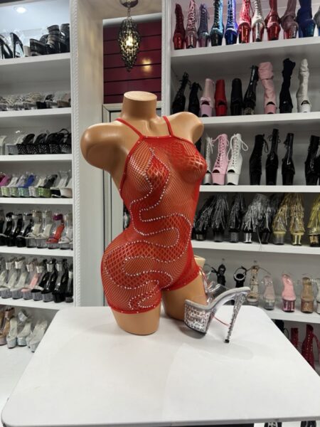 Model wearing red rhinestone fishnet romper with crystal swirl detailing