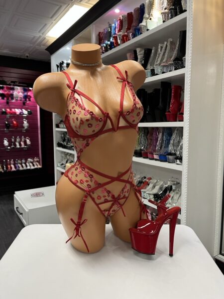 Ruby Kiss Sheer Teddy features soft mesh, embroidered lips, and strappy details for a flirty sculpted look.