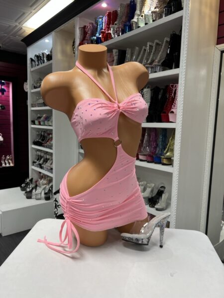 Pink rhinestone cutout dress with a halter neckline and adjustable side ruching. Flattering, bold, and designed to shine.