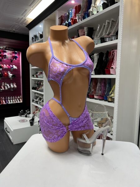 Lavender lace skirt romper with cutout design and flowing overlay