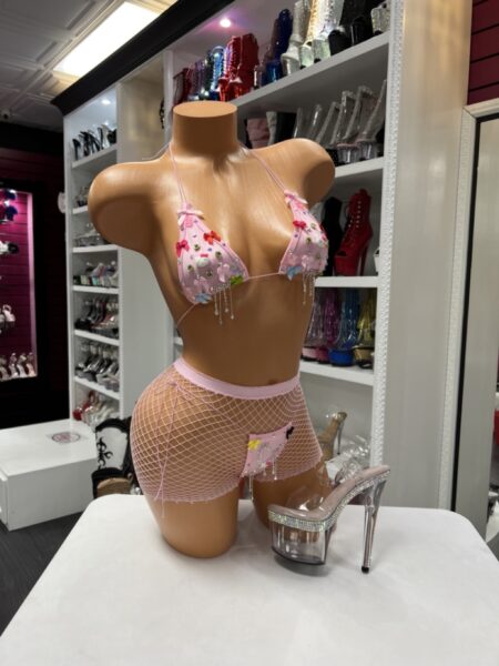 Pink charmed micro bikini with fishnet shorts and dangling charm details