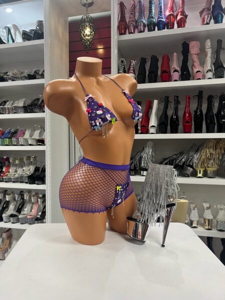 Purple bikini set with colorful charm details, rhinestones, and matching fishnet shorts