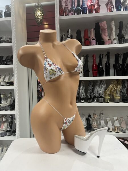 White kawaii bikini set with triangle top, matching string thong, slim white ties, and colorful cute character-inspired print.