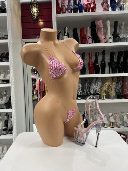 Pink bow print bikini with triangle top, matching string thong, slim pink ties, and playful pink patterned fabric.