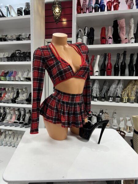 Model wearing red plaid Rebel Plaid Skirt Set with matching pleated skirt and bikini