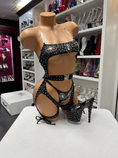Model wearing black rhinestone harness set with sparkling cutouts and strappy leg details