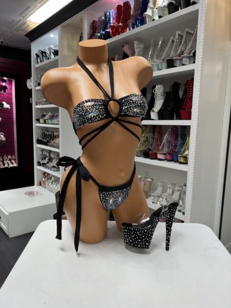 Model wearing black rhinestone wrap bikini with crystal embellishments and crisscross waist straps
