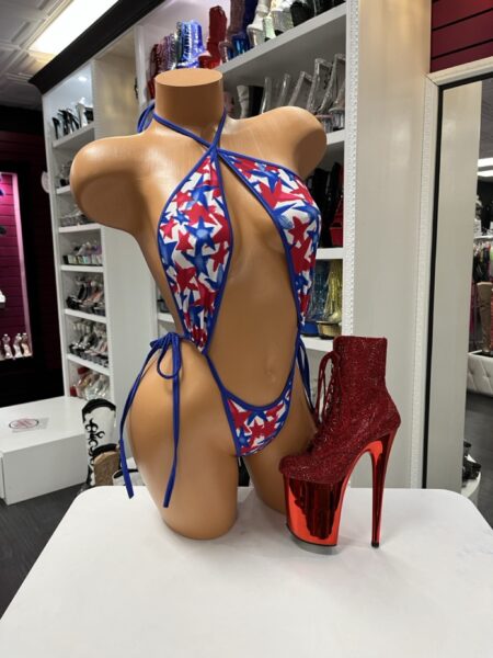 Firecracker Star Micro Romper with red white and blue starburst print blue trim halter tie neckline side ties and open front cutout