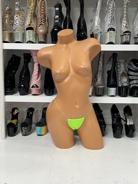 Lime green minimal thong with ultra thin string sides and bright neon color on mannequin