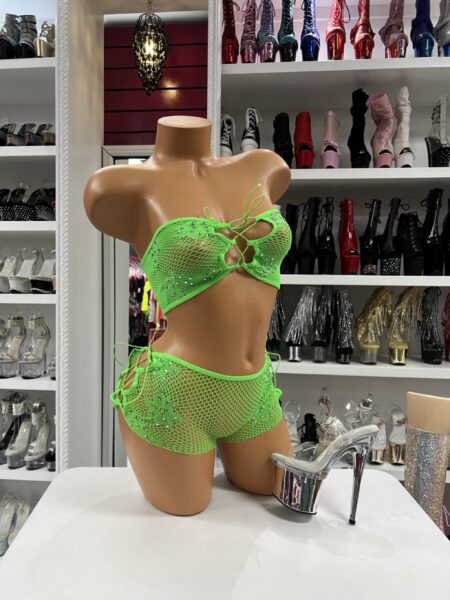 Neon Lime Crystal Fishnet two-piece set featuring crystal embellishments, fishnet overlay, lace-up bandeau top, and matching shorts.