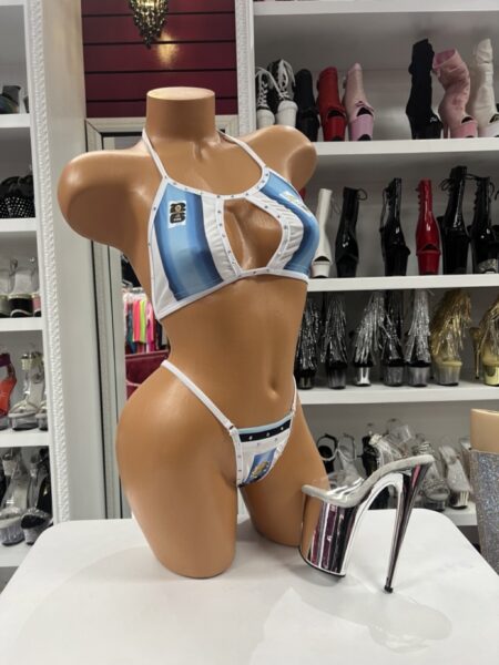 Argentine Pride Bikini featuring sky blue and white colors, cutout halter top, matching thong bottom, rhinestone accents, and Argentina-inspired styling.