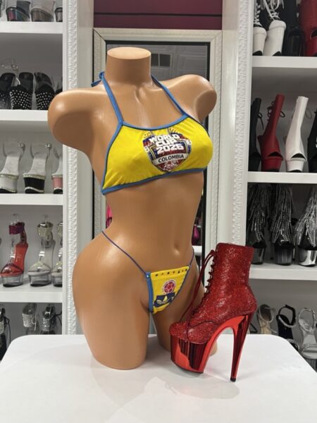 Colombian Fan Bikini Set featuring bright yellow fabric, blue trim, halter-style top, matching thong bottom, and colorful Colombia-inspired graphics.
