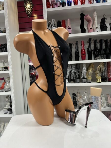 Black Lace Up Romper featuring a plunging lace-up front, silver-tone grommets, and dramatic open side styling.