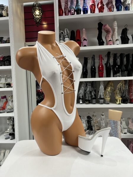 White Lace Up Romper featuring a plunging lace-up front, metallic grommets, and dramatic open side styling.