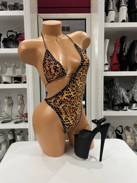 Cheetah Rhinestone Monokini featuring sparkling rhinestones, a plunging triangle halter neckline, dramatic side cutouts, adjustable tie closures, an open-back design, soft stretch fabric, and a classic cheetah print.