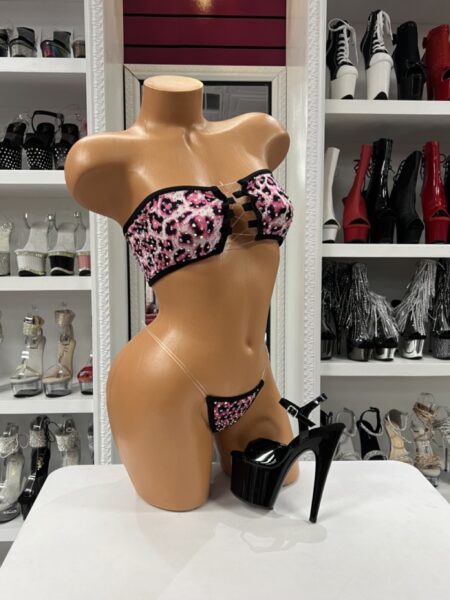 Pink Leopard Bikini featuring a rhinestone bandeau bikini top with an adjustable lace-up front, matching micro bikini bottom, bold pink leopard print, black trim, and sparkling embellishments.