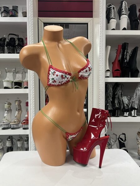 Cherry Print Micro Bikini featuring rhinestone embellishments, cherry print fabric, red trim, green string ties, triangle bikini top, and matching micro thong.