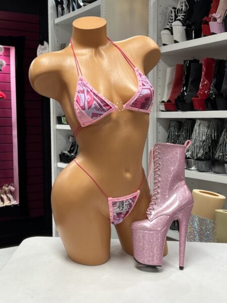 Pink Money Print Bikini featuring a dollar bill print, sparkling rhinestones, adjustable triangle string bikini top with a polished center ring, matching string bikini bottom, and soft stretch fabric.