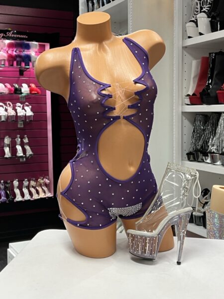Purple Rhinestone Mesh Romper featuring sheer mesh, rhinestone embellishments, lace-up front, and dramatic cutout styling.