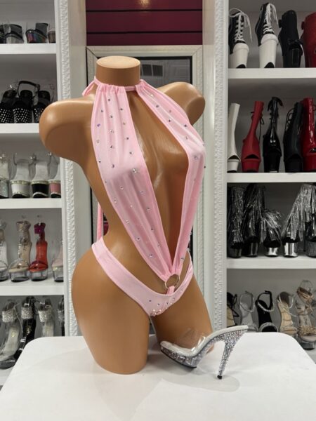 Baby Pink Rhinestone Romper featuring sparkling rhinestones, a halter neckline, dramatic plunging front, polished ring detail, open-back design, soft stretch fabric, and a flattering one-piece silhouette.