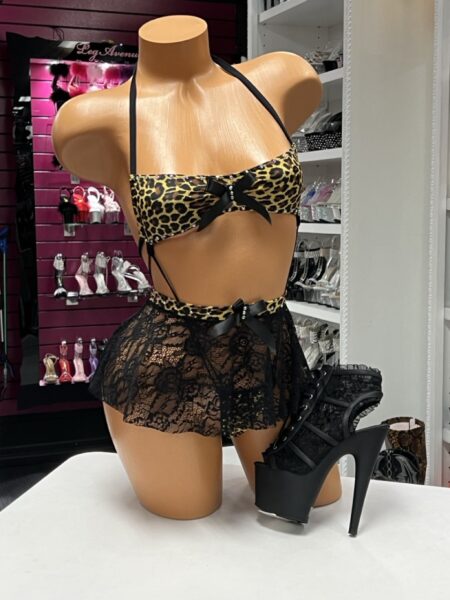 Leopard Lace Sling Set with leopard print sling bodysuit, removable black floral lace skirt, satin bow accents, and rhinestone details.