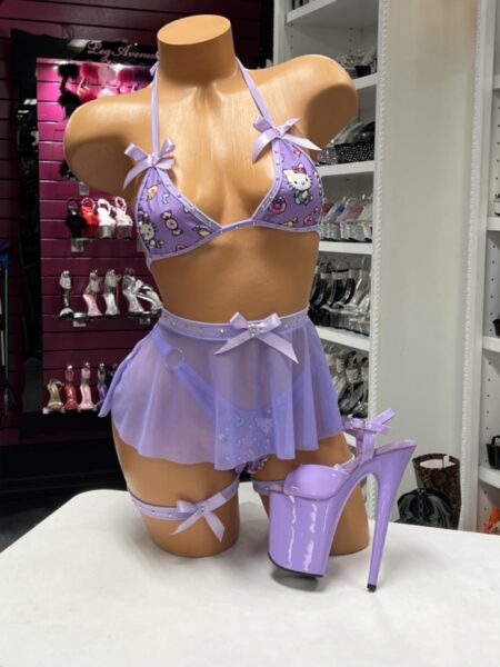 Purple Kawaii Micro Skirt Set featuring a character-inspired print, micro triangle halter top, matching micro G-string, sheer mesh mini skirt, satin bows, and rhinestone accents.