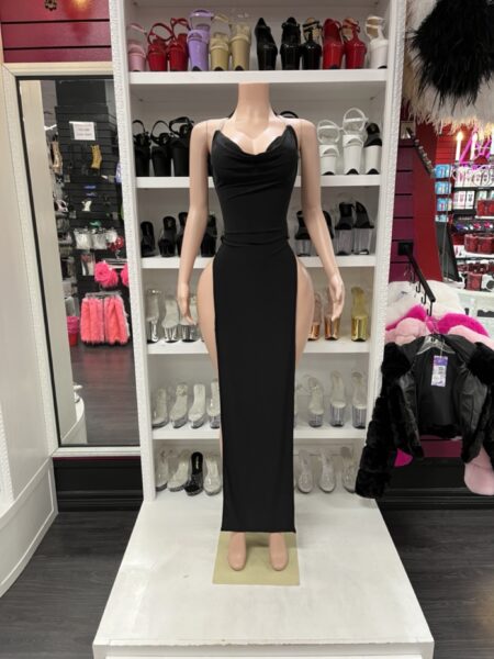 Black high slit dress with a draped cowl neckline, adjustable shoulder straps, fitted silhouette, and dramatic side slits.