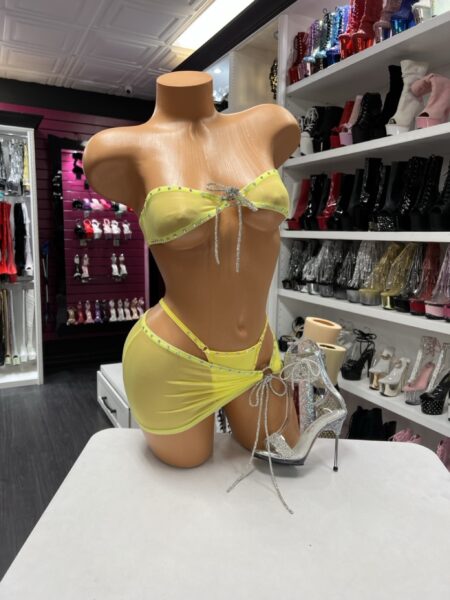 Lemon Rhinestone Skirt Set with rhinestone-trim bandeau top, side-tie mini skirt, attached thong, and sparkling adjustable center ties.