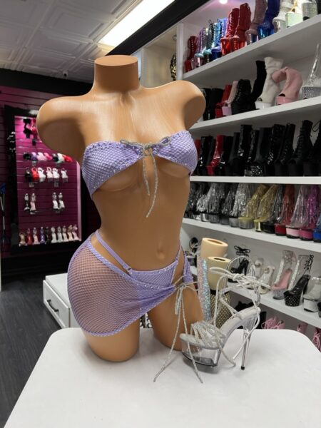 Lavender Fishnet Wrap Set with a fishnet bandeau top, matching wrap mini skirt, adjustable rhinestone drawstring ties, and lightweight stretch fabric.