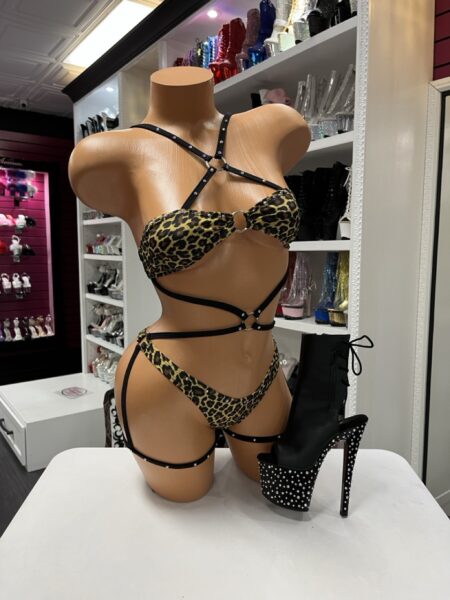 Leopard Strappy Ring Romper featuring leopard print fabric, metal ring accents, wraparound straps, and an attached leg strap.