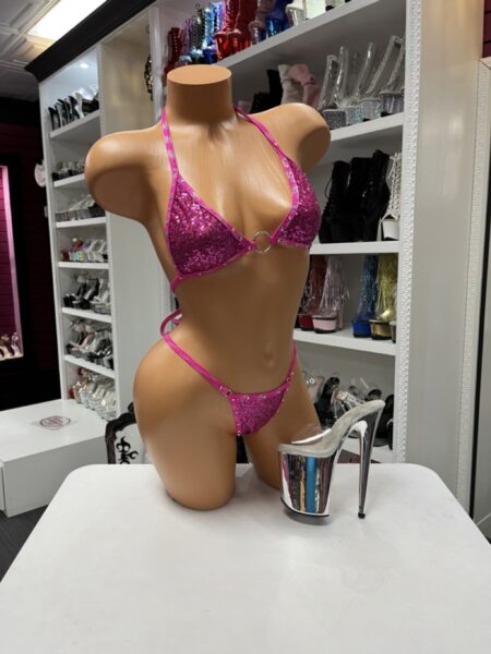 Pink sequin bikini with rhinestone trim, triangle halter top, silver O-ring detail, and matching thong bottom.