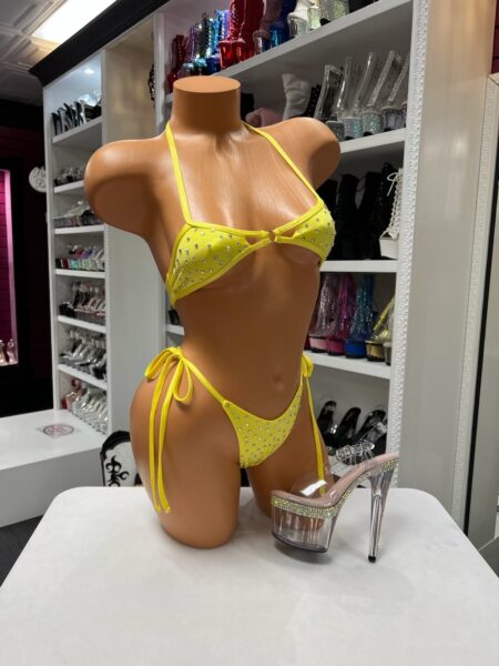 Yellow rhinestone bikini set with a ring-detail top, adjustable side-tie bottoms, and sparkling embellishments.