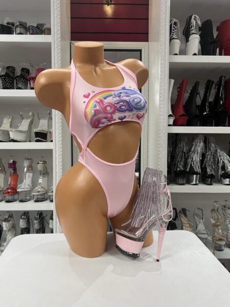 Pink Y2K Cutout Monokini featuring a colorful dolphin and rainbow graphic, halter neckline, front cutout, and flattering one piece swimsuit design.