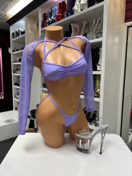 Lavender sleeve slingshot set featuring a bandeau-style top, sheer mesh sleeves, rhinestone accents, and matching high-cut bottoms.