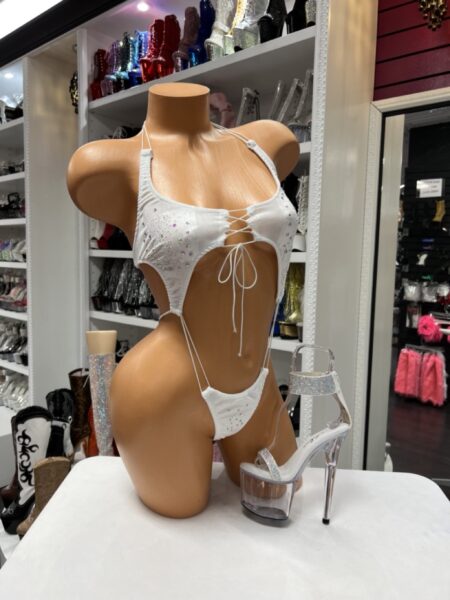 White rhinestone string romper with a halter neckline, lace-up front, slim string design, and sparkling rhinestone embellishments.
