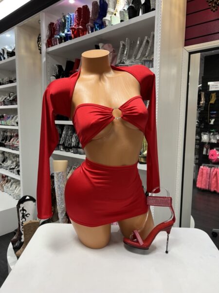 Red two piece skirt set with a bandeau crop top, detachable long sleeves, rhinestone ring detail, and matching mini skirt.