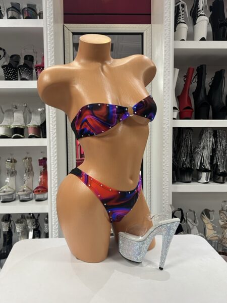 Color Flow Bikini Set is a vibrant 2-piece bikini featuring an abstract flowing color print, sparkling crystal embellishments, and a decorative center ring. Perfect for festivals, performances, content creation, themed events, and photoshoots, this fashion-forward set is designed for statement styling and is not intended as functional swimwear.