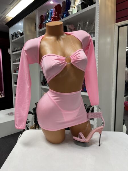 Pink sleeve skirt set with a bandeau crop top, rhinestone ring detail, detachable long sleeves, and matching mini skirt.
