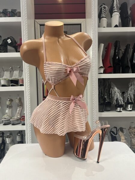 Blush Bow Sling Set featuring a textured sling bodysuit with matching mini skirt, satin bows, side cutouts, and crystal trim.