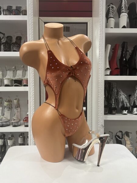 Copper Velvet Romper with sparkling rhinestones, adjustable shoulder straps, lace-up front, bold front and side cutouts, and soft stretch velvet fabric.